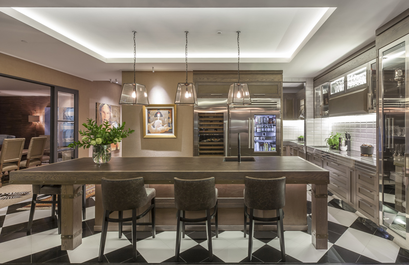 Continuing the wallpaper and artwork into the kitchen helps blur the lines between spaces.