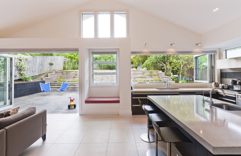 In this villa extension, the exterior wall was deepened to accommodate a simple built-in seat and the adjacent kitchen benchtop.